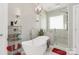 This bathroom includes a tub, modern light fixtures, and a modern shower with a glass door at 2003 Dataw Ln, Indian Trail, NC 28079