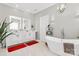 This bathroom includes double sinks, a modern tub, neutral tones, and modern light fixtures at 2003 Dataw Ln, Indian Trail, NC 28079