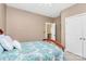 Cozy bedroom with a blue and white bedspread, closet, and white door at 2003 Dataw Ln, Indian Trail, NC 28079