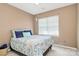 This bedroom offers neutral walls, a ceiling fan, and a window with blinds at 2003 Dataw Ln, Indian Trail, NC 28079