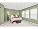 Spacious bedroom with light-green walls, soft carpet, and ample natural light from three large windows at 2003 Dataw Ln, Indian Trail, NC 28079