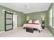 This bedroom offers a sliding barn door, a ceiling fan and light, and neutral tones at 2003 Dataw Ln, Indian Trail, NC 28079