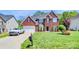 Beautiful two-story brick home featuring well-manicured landscaping, an attached garage and a large driveway at 2003 Dataw Ln, Indian Trail, NC 28079