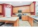 Charming kitchen features wood cabinets, stainless steel appliances, and neutral tile flooring at 2003 Dataw Ln, Indian Trail, NC 28079