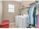 This laundry room is equipped with a washer, dryer, and shelving at 2003 Dataw Ln, Indian Trail, NC 28079
