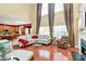 Open-concept living area with hardwood floors, fireplace, large windows, and seamlessly connected to the kitchen at 2003 Dataw Ln, Indian Trail, NC 28079