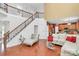 Open-concept living room with hardwood floors, staircase and seamlessly connected to the kitchen at 2003 Dataw Ln, Indian Trail, NC 28079
