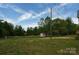 Expansive backyard with lush green grass and an outbuilding at 2019 Kingston Rd, Kingstown, NC 28150