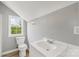 Bathroom featuring toilet, sink, vanity, and a window at 2019 Kingston Rd, Kingstown, NC 28150