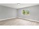 Bedroom featuring neutral walls, white trim, a window with green view, and light hardwood floors at 2019 Kingston Rd, Kingstown, NC 28150