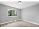 Bright bedroom featuring light gray walls, wood-look floors, and a window with natural outdoor views at 2019 Kingston Rd, Kingstown, NC 28150