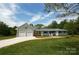Charming house featuring an attached two-car garage, complemented by a well-manicured lawn and a long driveway at 2019 Kingston Rd, Kingstown, NC 28150