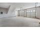 Spacious two-car garage with bright concrete flooring and white doors at 2019 Kingston Rd, Kingstown, NC 28150