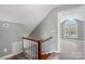 Hallway with wood stairs, gray walls, and an arched window illuminating the space at 2019 Kingston Rd, Kingstown, NC 28150