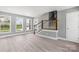 Bright living room featuring wood flooring, fresh paint, staircase, and multiple windows at 2019 Kingston Rd, Kingstown, NC 28150