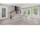 Spacious living room featuring wood flooring, fresh paint, staircase, and a door to a porch at 2019 Kingston Rd, Kingstown, NC 28150