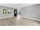 Spacious living room featuring modern wood flooring, fresh gray paint, and natural lighting at 2019 Kingston Rd, Kingstown, NC 28150
