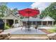 Backyard patio featuring an outdoor dining area and views of a lush backyard with mature trees at 206 Oxford Place Dr, Fort Mill, SC 29715