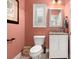 Cozy powder room featuring a white vanity, granite countertop, and decorative mirror and window at 206 Oxford Place Dr, Fort Mill, SC 29715