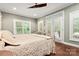 Comfortable bedroom featuring wood floors, crown molding, and French doors at 206 Oxford Place Dr, Fort Mill, SC 29715