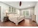 Comfortable bedroom featuring wood floors, crown molding, and plantation shutters at 206 Oxford Place Dr, Fort Mill, SC 29715