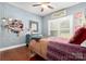 Bright bedroom featuring light blue walls, wood floors, and a ceiling fan at 206 Oxford Place Dr, Fort Mill, SC 29715