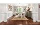 Formal dining room with wainscoting, hardwood floors, and an elegant chandelier for stylish entertaining at 206 Oxford Place Dr, Fort Mill, SC 29715