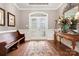 Elegant foyer featuring wood floors, a decorative mirror, and a beautiful front door with detailed ironwork at 206 Oxford Place Dr, Fort Mill, SC 29715