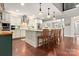 Bright and modern kitchen with an island, stainless steel appliances, and hardwood floors at 206 Oxford Place Dr, Fort Mill, SC 29715