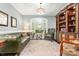 Cozy living room with a built-in bookshelf, a decorative rug, and natural light from the window at 206 Oxford Place Dr, Fort Mill, SC 29715