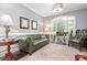 Comfortable living room with hardwood floors, a decorative rug, and natural light from the window at 206 Oxford Place Dr, Fort Mill, SC 29715