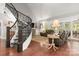 Living room with spiral staircase, hardwood floors, and a cozy seating area near large windows at 206 Oxford Place Dr, Fort Mill, SC 29715