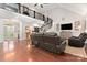 Inviting living room featuring a spiral staircase, hardwood floors, and comfortable seating at 206 Oxford Place Dr, Fort Mill, SC 29715