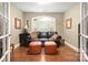 Comfortable living room with a leather sofa, ottoman, and window providing natural light at 206 Oxford Place Dr, Fort Mill, SC 29715