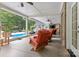 Relaxing screened porch with cozy seating and a view of the inviting backyard pool at 206 Oxford Place Dr, Fort Mill, SC 29715
