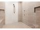 Spacious tiled shower featuring a built in bench and rain shower head at 206 Oxford Place Dr, Fort Mill, SC 29715