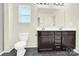 Bright bathroom features a double sink vanity, granite counters, and a framed mirror at 207 Aspire Cir # 46, Wingate, NC 28174