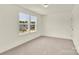 Bedroom with large window for natural light, carpet, and door at 207 Aspire Cir # 46, Wingate, NC 28174