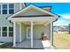 Inviting covered patio with white pillars, ceiling fan, and grill at 207 Aspire Cir # 46, Wingate, NC 28174