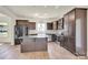 Spacious kitchen featuring dark cabinets, stainless steel appliances, and a functional center island at 207 Aspire Cir # 46, Wingate, NC 28174