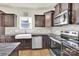 Modern kitchen features stainless steel appliances, granite counters, and dark wood cabinets at 207 Aspire Cir # 46, Wingate, NC 28174