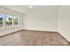 Bright, airy living room with hardwood floors and large windows offering plenty of natural light at 207 Aspire Cir # 46, Wingate, NC 28174