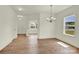 Bright and airy living room features hardwood floors, neutral walls, and large windows at 207 Aspire Cir # 46, Wingate, NC 28174