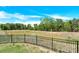 Beautiful pond view surrounded by a black metal fence and lush trees at 207 Aspire Cir # 46, Wingate, NC 28174