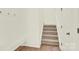 Carpeted staircase with white banister and trim at 207 Aspire Cir # 46, Wingate, NC 28174