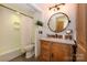Charming bathroom with wood vanity, marble top, and updated fixtures at 217 W 8Th St, Charlotte, NC 28202