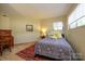 Cozy bedroom featuring a patterned rug, desk and chair, and a bright window at 217 W 8Th St, Charlotte, NC 28202