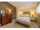 Inviting bedroom with a brick accent wall, decorative lamps, and comfortable furnishings at 217 W 8Th St, Charlotte, NC 28202