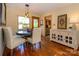 Charming dining area features hardwood floors, a buffet cabinet, pendant lighting and backyard views at 217 W 8Th St, Charlotte, NC 28202