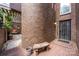 Exterior of a brick building entrance with decorative bench and seating area at 217 W 8Th St, Charlotte, NC 28202